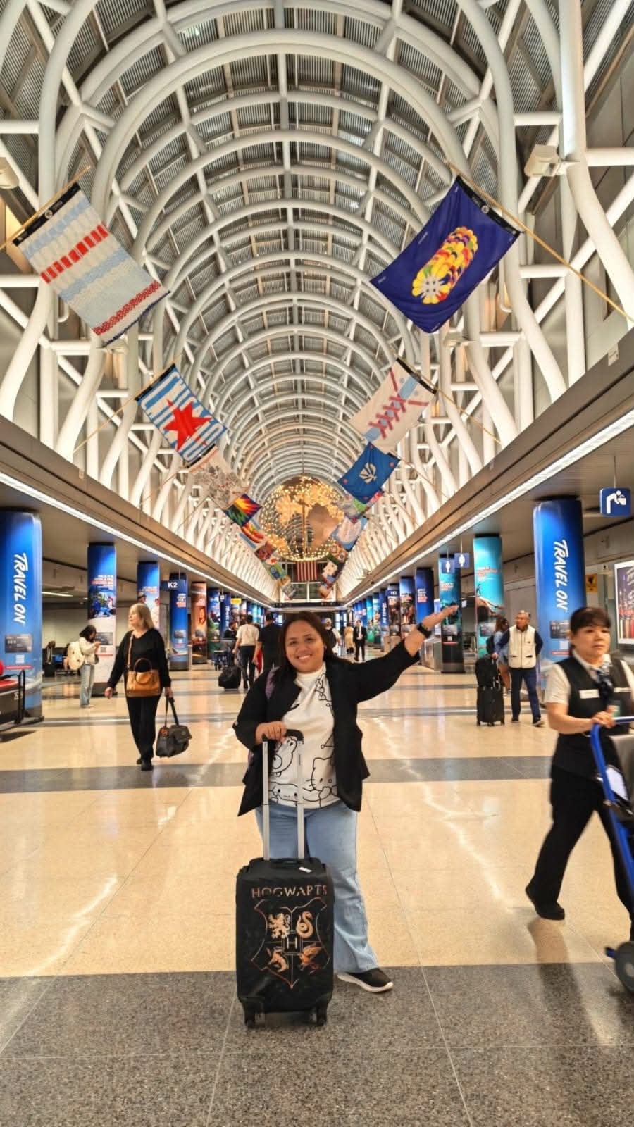 CrossBorder teacher at Chicago O'Hare airport with Hogwarts luggage