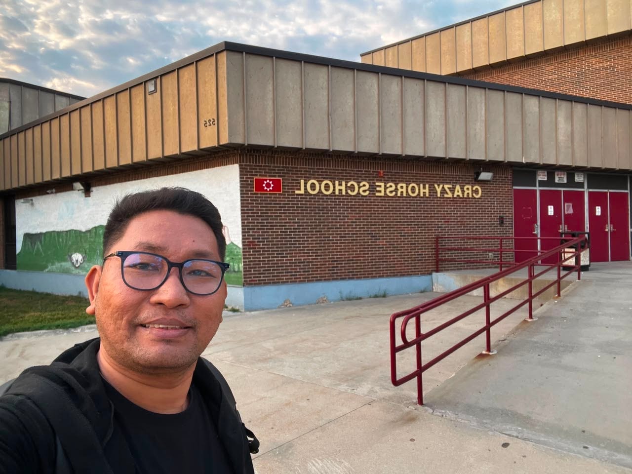 CrossBorder teacher selfie at school exterior
